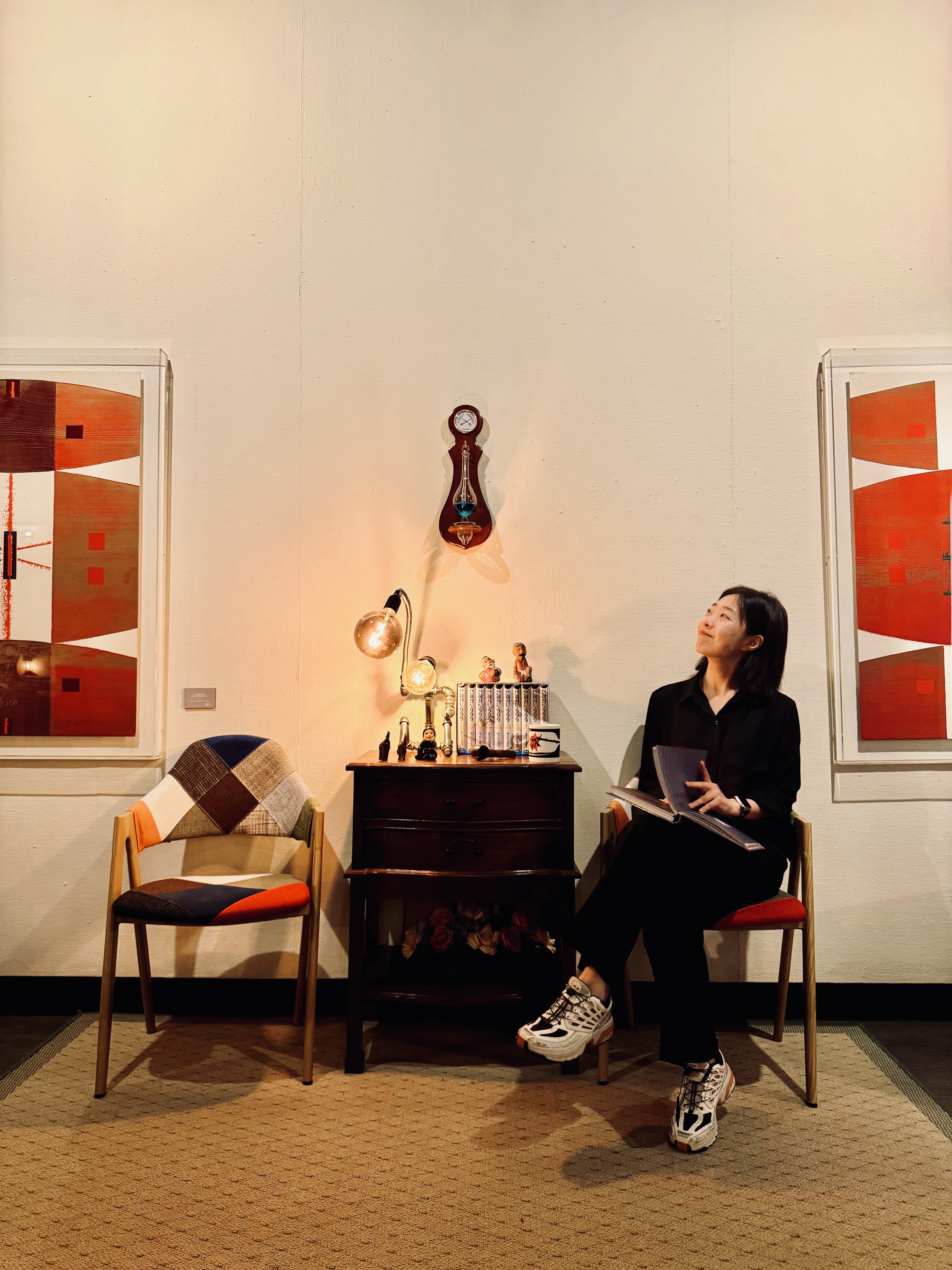 A visitor browsing the Archive reading room at Moon Art Grounds — a curated library of art books, design publications, and photography collections gathered since 1985