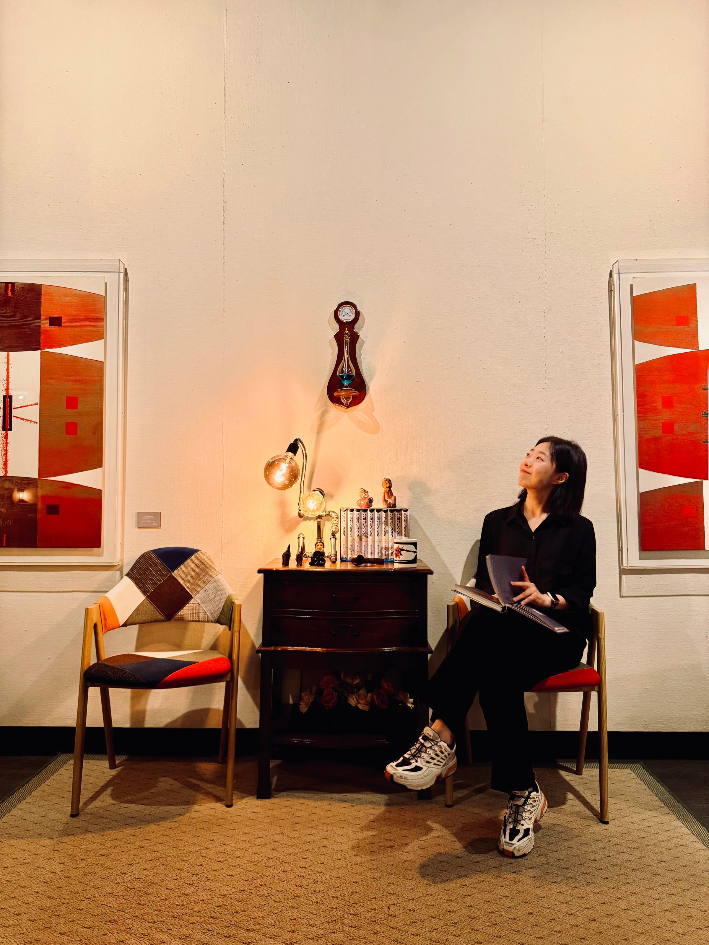A visitor browsing the Archive reading room at Moon Art Grounds — a curated library of art books, design publications, and photography collections gathered since 1985